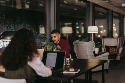 Man and woman in office at night