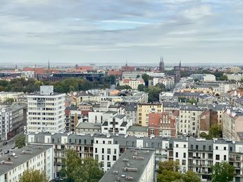 High angle view of buildings in city against sky