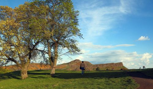 Man on golf course against sky