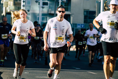 People running on street in city