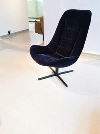 Side view of a young woman sitting on chair