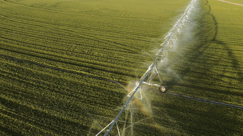 Aerial view of agricultural sprinkler spraying field