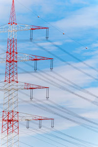 Low angle view of electricity pylon against sky