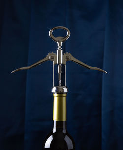 Close-up of beer bottle against blue background