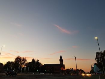 Silhouette of building against sky during sunset