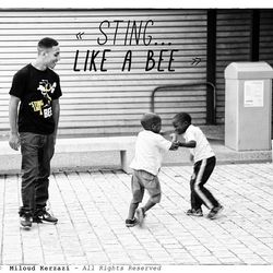 Full length of boys standing on street in city