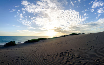 Scenic view of beach against sky during sunset