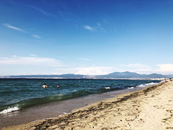 Scenic view of beach against blue sky