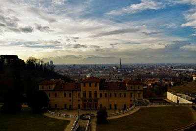 Cityscape against cloudy sky