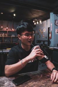 Young man having coffee in restaurant