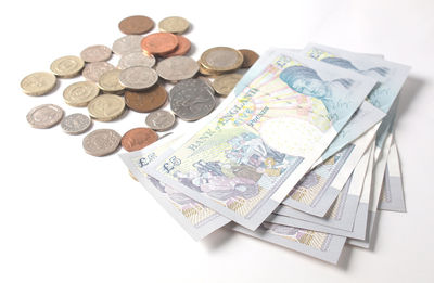 Close-up of coins over white background