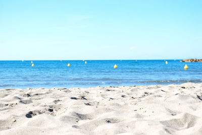 Scenic view of sea against clear blue sky