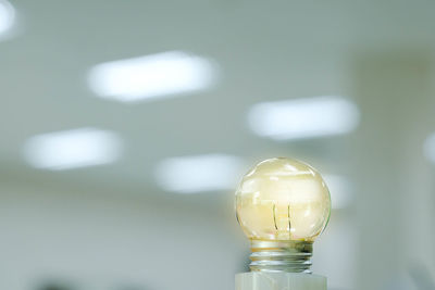 Close-up of light bulb on table