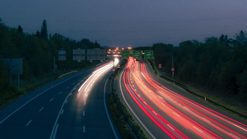 High angle view of light trails on road at night