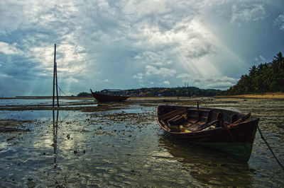 Boat moored in sea against sky