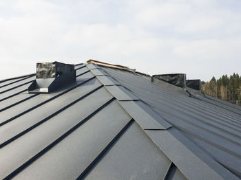 Low angle view of roof and building against sky