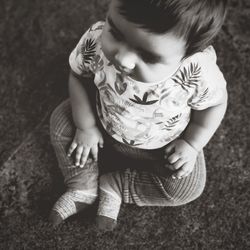 High angle view of cute girl sitting outdoors