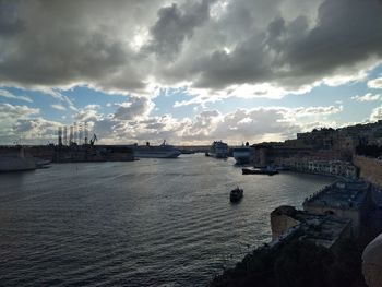 View of bridge over river against cloudy sky