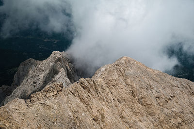Scenic view of mountain against clouds and sky
