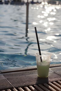 Close-up of drink on pool side