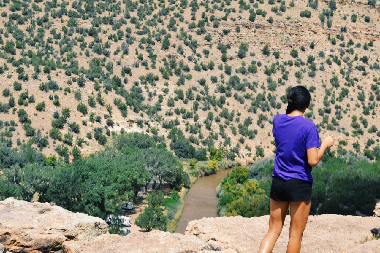 lifestyles, casual clothing, leisure activity, standing, full length, rear view, nature, landscape, men, beauty in nature, tranquility, tranquil scene, rock - object, plant, scenics, mountain, person, walking