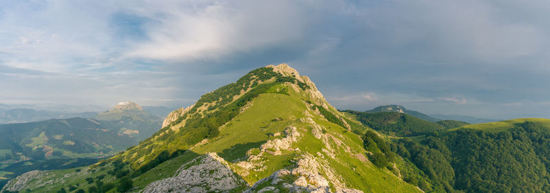 Panoramic view of green landscape against sky