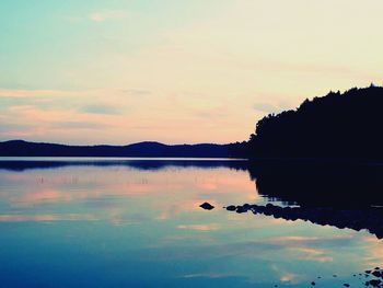 Scenic shot of calm lake at sunset