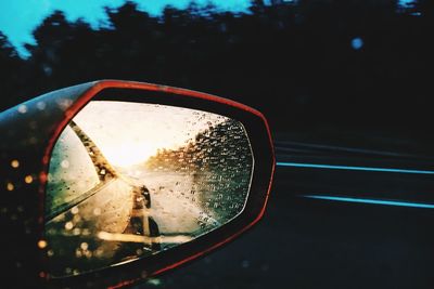 Side-view mirror of car during rainy season