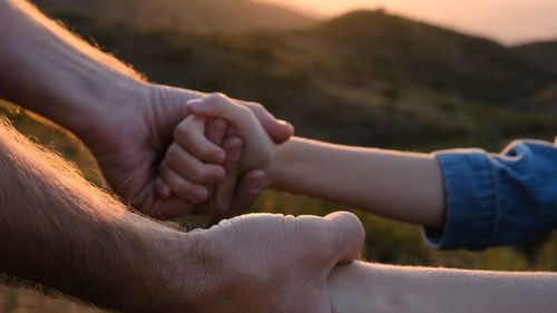 Cropped image of couple holding hands