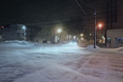 Snow covered road at night