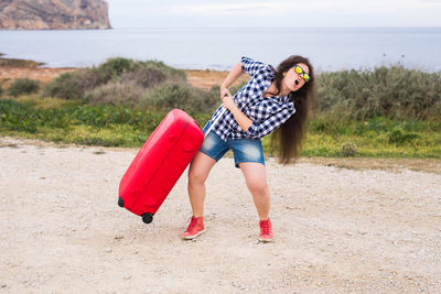 Full length portrait of woman on road