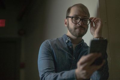 Portrait of young man using mobile phone