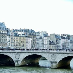 Bridge over river with buildings in background