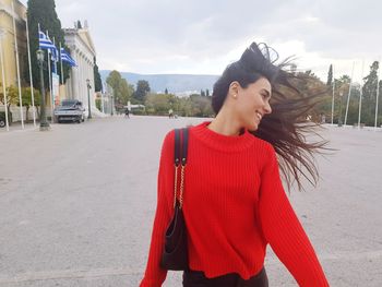 Young woman standing on street in city