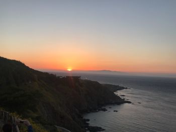 Scenic view of sea against clear sky during sunset