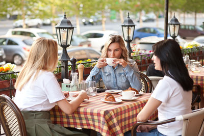 Women sitting on table at restaurant