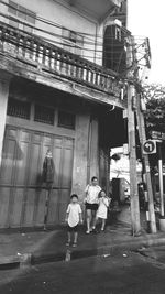 Full length of woman standing by railing