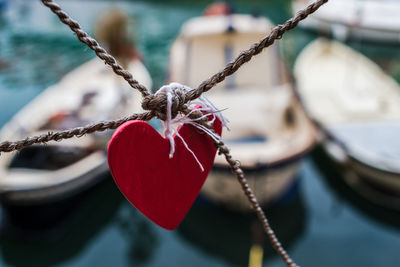 Close-up of heart shape hanging on rope