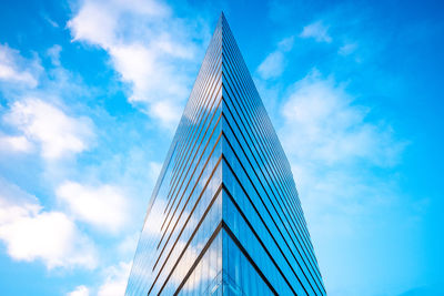 Low angle view of modern building against blue sky