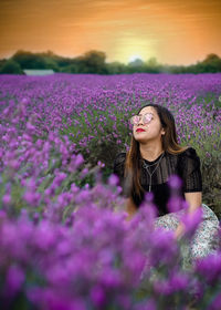 Woman with pink flowers on field