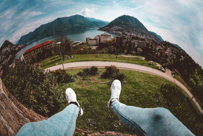 Low section of man on mountain against sky