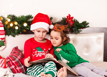 Portrait of boy sitting on sofa at home