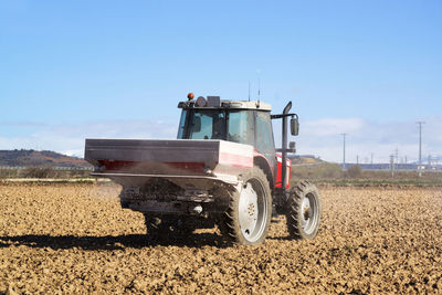 Tractor sowing seeds the crop field , farm equipment woriking in field