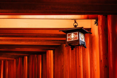 Low angle view of lantern hanging on ceiling of building