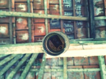 Close-up of rusty metal railing against building