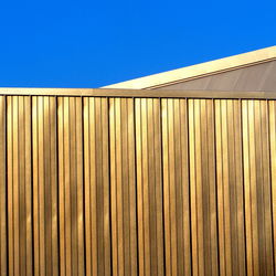 Low angle view of roof against blue sky