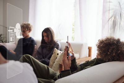 Young man reading fake news on digital display