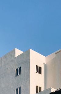 Low angle view of building against clear blue sky