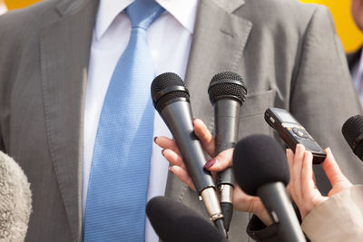 Cropped image of journalist interviewing businessman