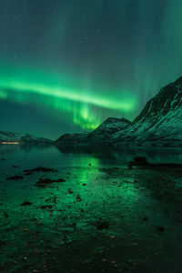 Scenic view of lake against sky at night